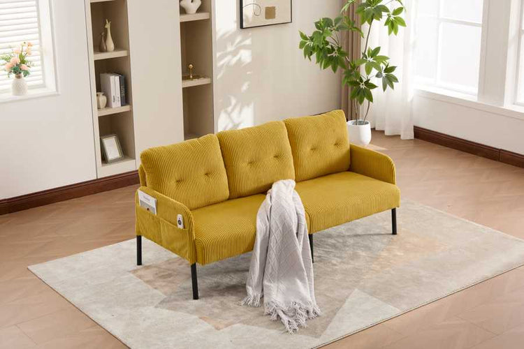 Yellow sofa with a white blanket in a room with bookshelves and plants