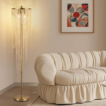 Gold floor lamp for living room with cascading crystal strands beside a cream tufted sofa, adding elegance to modern home decor.