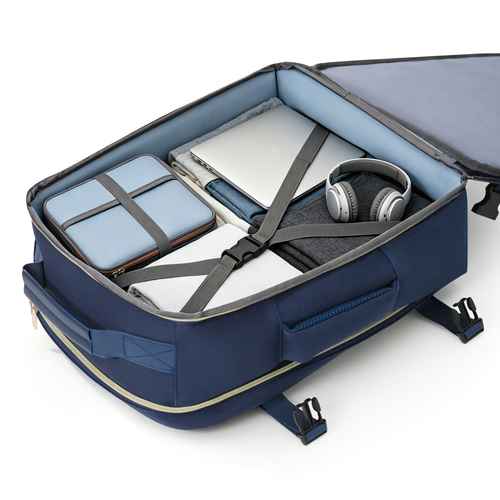 Open navy suitcase with packed items on a white background