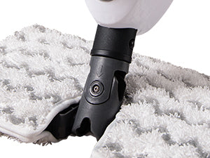 Close-up of a black and white floor mop head attachment pressed against a white textured floor mat.