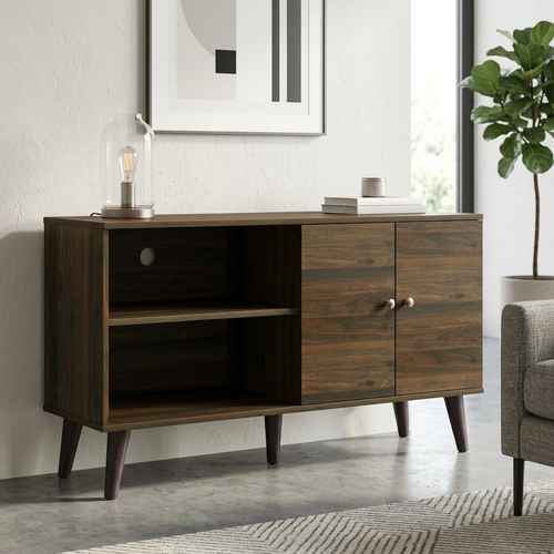 Dark wood modern TV stand with two open shelves, a cabinet with two doors, and angled legs, placed against a white wall with decor
