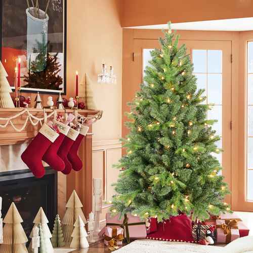 4 ft green Christmas tree with lights beside stockings