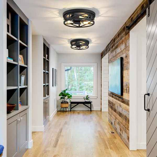 Modern interior hallway with bookshelves, a TV on a wooden wall, and a window.
