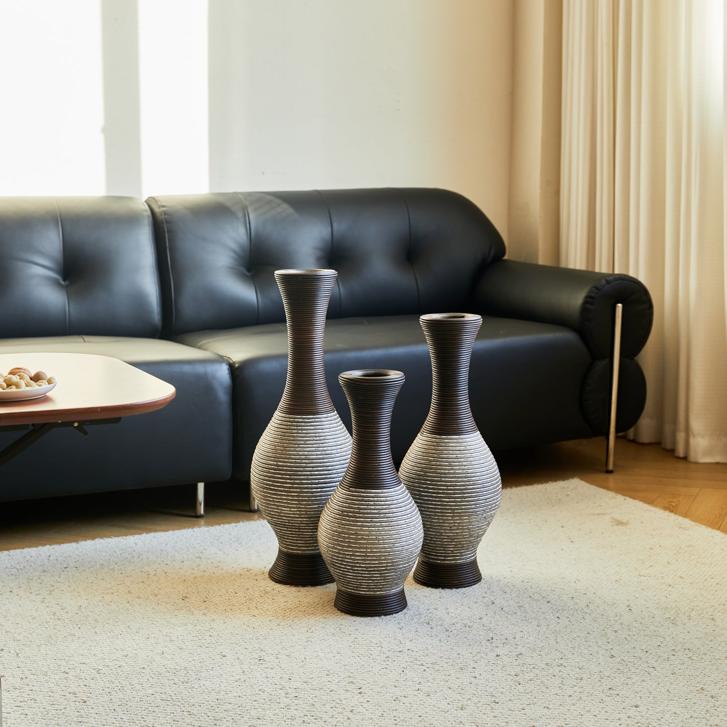 Brown floor vase set of 3 arranged on a white rug in front of a black sofa, perfect for stylish home and garden décor.