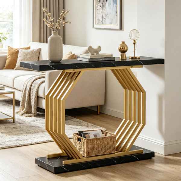A modern console table with a black marble-look top and base, and a geometric gold metal frame, styled in a bright living room next to a beige sofa.