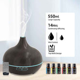 A dark brown essential oil diffuser with misting visible from the top, shown on a light surface with a remote control and several small essential oil bottles. A white information panel on the right lists features: 550ml large capacity, 14 hours continuing diffusing, mist control, and top refill design.