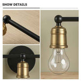 Light fixture with brass socket and clear bulb on a wooden surface.