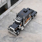 Black truck with flame design on a concrete surface