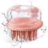 Pink scalp massager with clear top on a white background