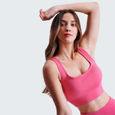 Model in pink yoga set with raised arm pose, highlighting the stylish and supportive fit of Seamless Tummy Control Yoga Pants.