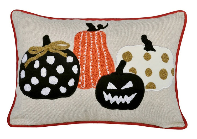 Decorative pillow with Halloween-themed pumpkins on a beige background