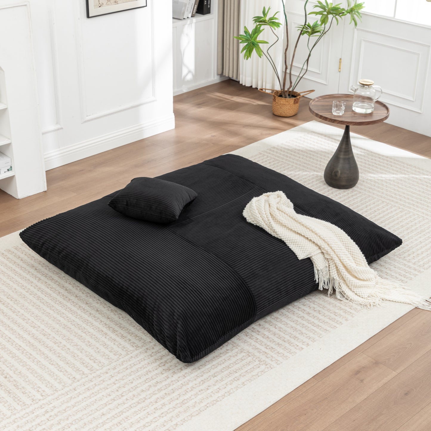 Corduroy Bean Bag Chair - Lounger for Adults & Kids in black laid flat with pillow and throw, ideal for modern living spaces.