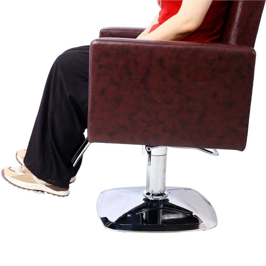 Side view of person sitting on salon chair, showcasing armrest height and seat depth for optimal client positioning.