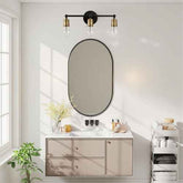 A modern bathroom vanity scene with a wall-mounted oval mirror, three-light wall sconce above, a beige floating cabinet with a white countertop, and toiletries on a white shelving unit.