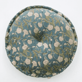 Round fabric cushion with floral pattern on a white background