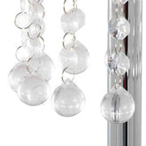 Close-up of a decorative hanging ornament with clear glass balls and silver chains on a white background.