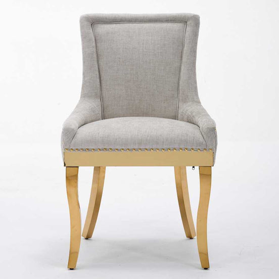 Gray upholstered chair with gold legs on a white background