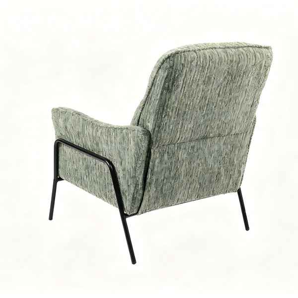 A mid-century modern accent chair with textured sage green and gray bouclé upholstery and a black metal frame, shown from a rear three-quarter angle on a white background.
