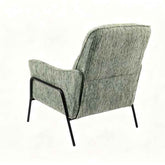 A mid-century modern accent chair with textured sage green and gray bouclé upholstery and a black metal frame, shown from a rear three-quarter angle on a white background.