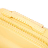 Close-up of yellow ABS luggage with zipper closure and smooth surface for secure packing and travel convenience