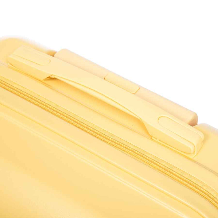 Close-up of yellow ABS luggage with zipper closure and smooth surface for secure packing and travel convenience