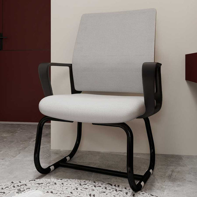 Modern office chair with black frame and gray cushion against a neutral wall.