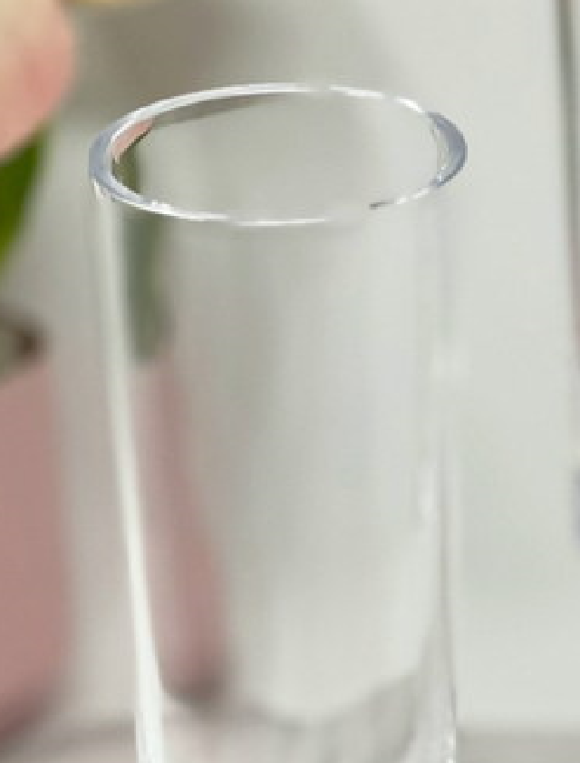 Close-up of the rim and upper portion of a blue acrylic unbreakable champagne flute, highlighting its smooth finish and durability.