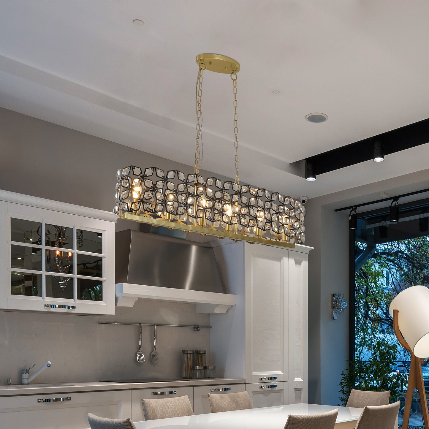 a chandelier hanging over a kitchen table