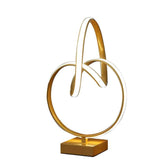 Gold decorative object with interlocking rings on a white background