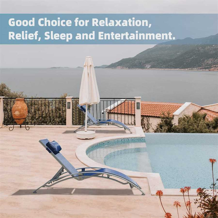 Outdoor setting with lounge chairs, umbrella, and pool overlooking a scenic landscape.