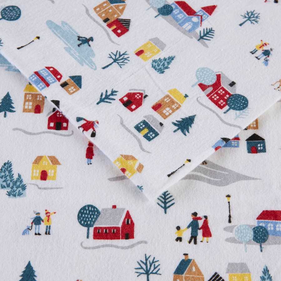 Detailed view of the 3 PCS Twin XL Printed Sheet Set's White Village Print, showing cozy winter scenes and soft brushed cotton flannel.