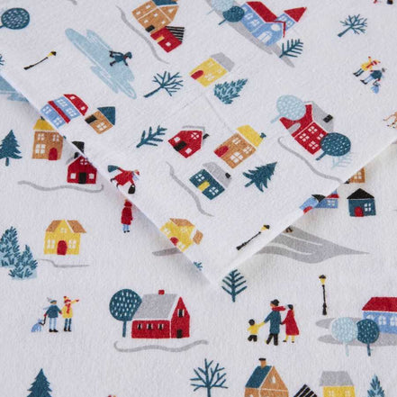 Detailed view of the 3 PCS Twin XL Printed Sheet Set's White Village Print, showing cozy winter scenes and soft brushed cotton flannel.