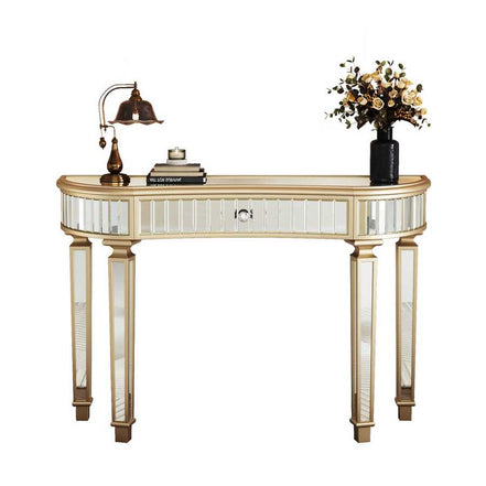 Front view of Half-Moon Mirrored Console Table with fluted glass and gold accents, styled with books and floral decor.