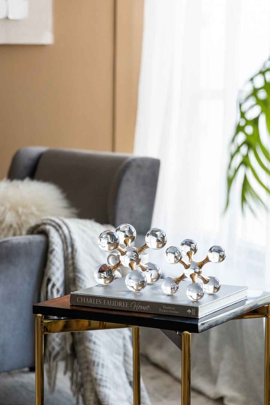 Decorative object on a book on a side table in a living room setting