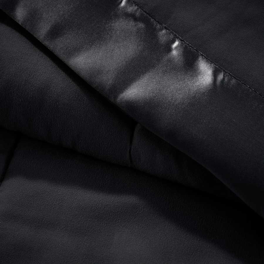 Detailed view of black Lightweight Down Alternative Blanket fabric and satin trim, emphasizing smooth texture and high-quality finish.
