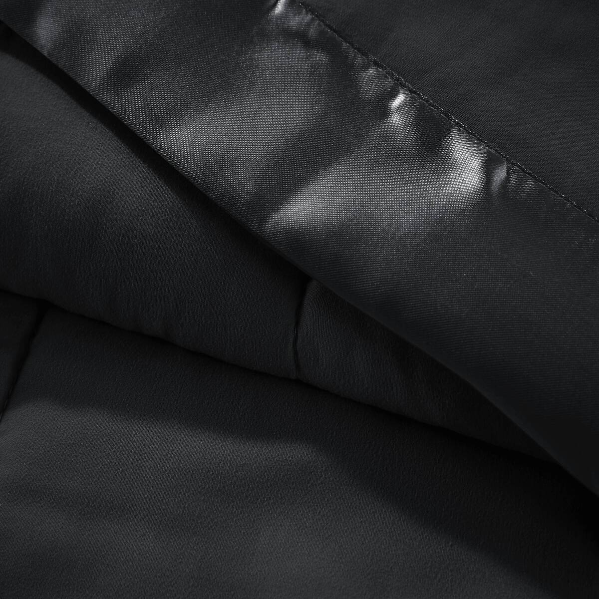 Detailed view of black Lightweight Down Alternative Blanket fabric and satin trim, emphasizing smooth texture and high-quality finish.