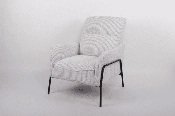 A modern armchair upholstered in a textured cream and light gray striped bouclé fabric, featuring a black metal frame and legs, photographed against a neutral light gray studio background.