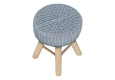 Round stool with knitted blue top and wooden legs on a white background