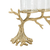 A gold-finished metal candle holder designed like a tree trunk with branching branches, holding two clear glass candle sleeves, shown on a white background.