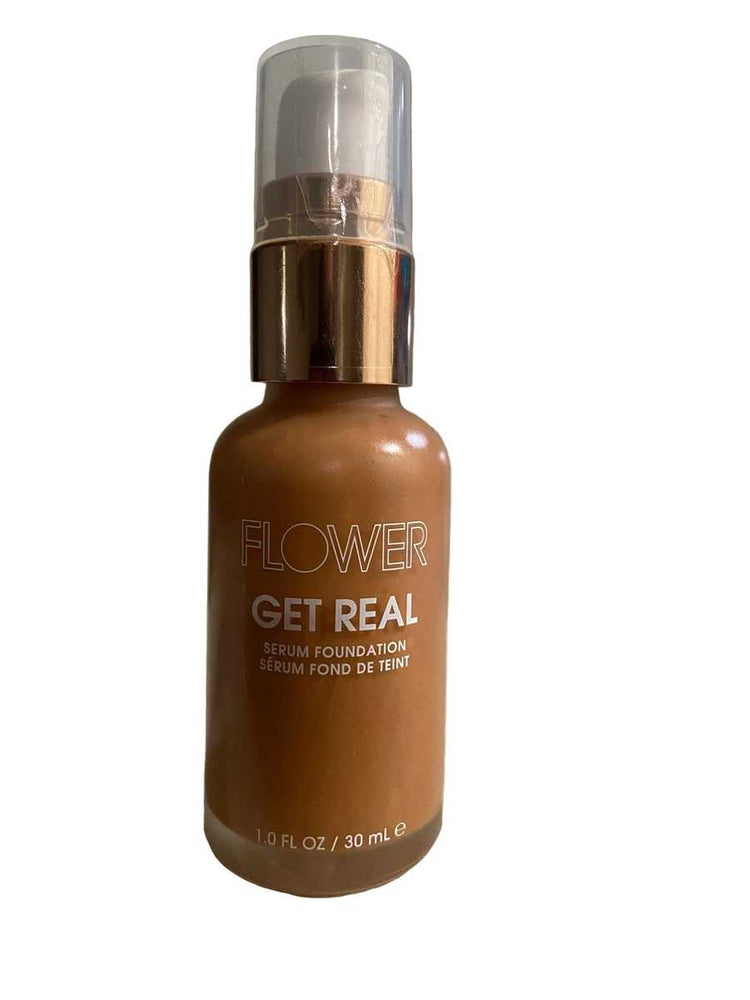 Flower Get Real foundation bottle on a textured surface