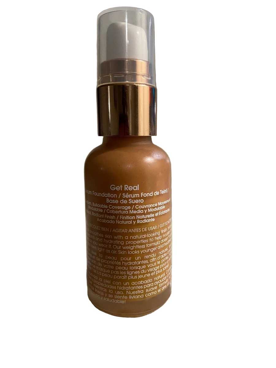 Brown bottle with gold cap on a textured surface