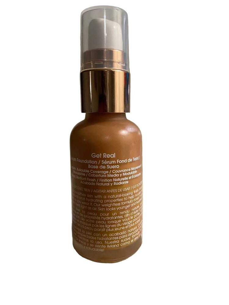 Brown bottle with gold cap on a textured surface