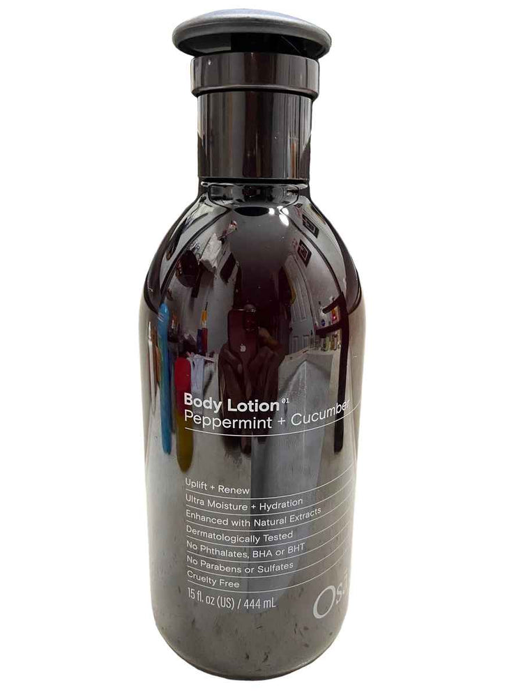 Bottle of body lotion with a pump on a textured surface