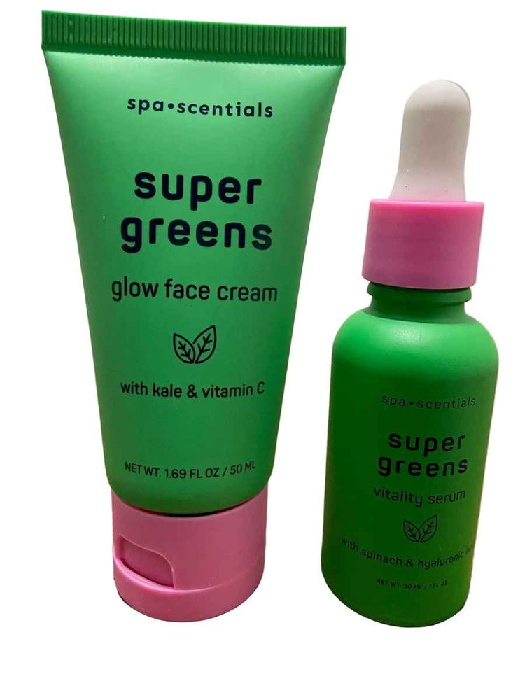Spa-centricals Super Greens Glow Face Cream in a green squeeze tube with a pink cap, shown next to a matching green dropper bottle with a pink collar on a wooden surface.