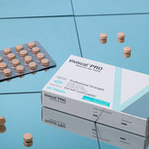 Viviscal Pro supplement box with tablets on a reflective blue surface