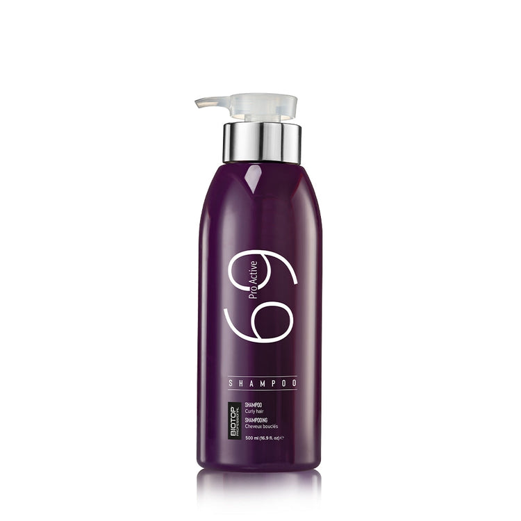 Purple shampoo bottle with pump on a white background