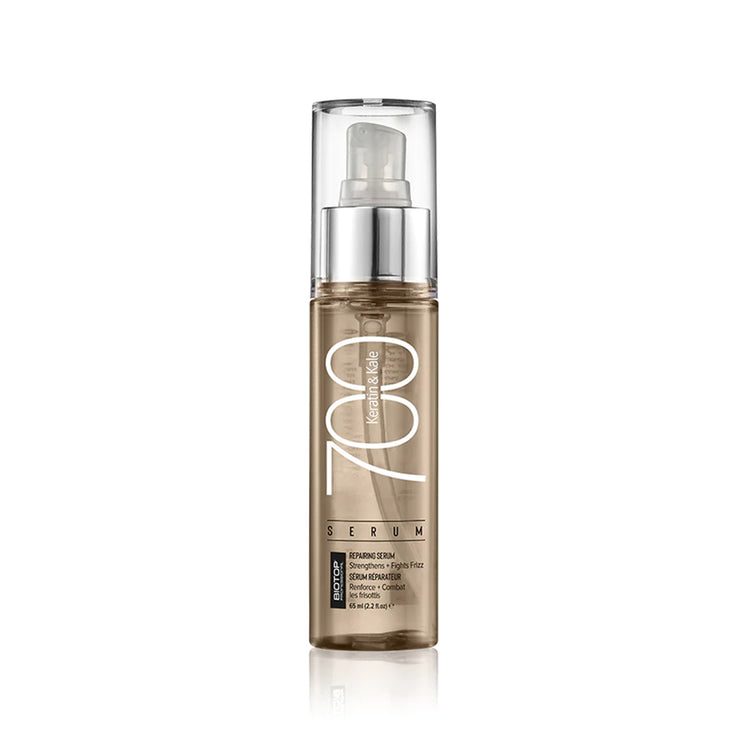 Skincare serum bottle with pump on a white background