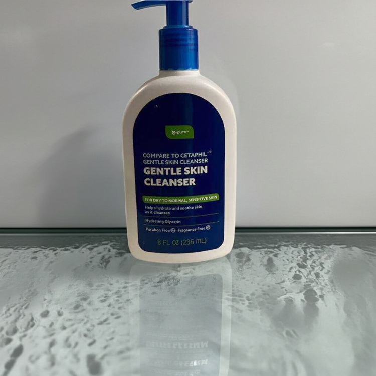 Bottle of gentle skin cleanser on a reflective surface with a neutral background