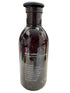 Bottle of body lotion with a pump on a textured surface
