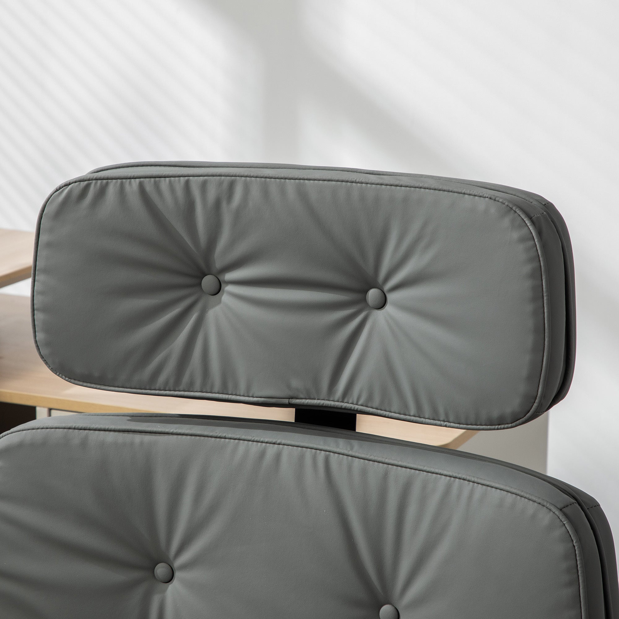 Gray cushioned office chair with a white background